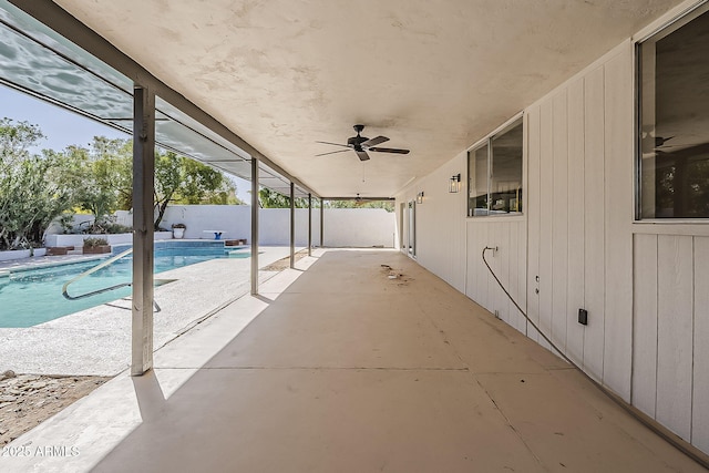 view of patio / terrace featuring a ceiling fan, a fenced in pool, a fenced backyard, and a lanai