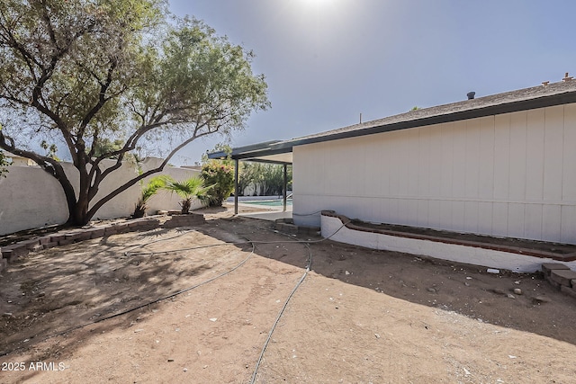 view of side of home featuring a fenced backyard