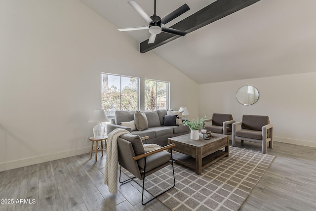 living room with ceiling fan, high vaulted ceiling, baseboards, light wood-type flooring, and beamed ceiling