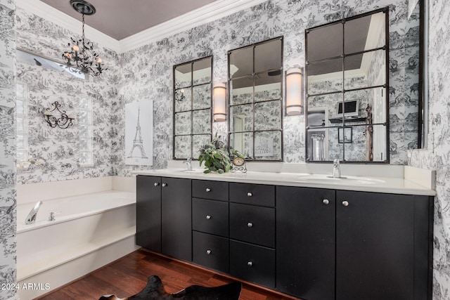 bathroom with vanity, an inviting chandelier, a bathing tub, crown molding, and wood-type flooring