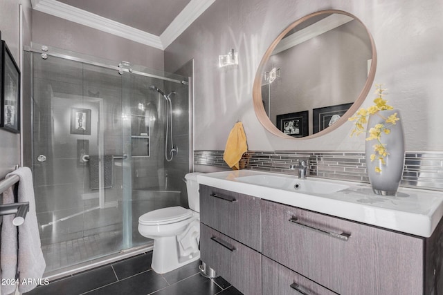 bathroom featuring decorative backsplash, vanity, a shower with door, tile patterned flooring, and toilet