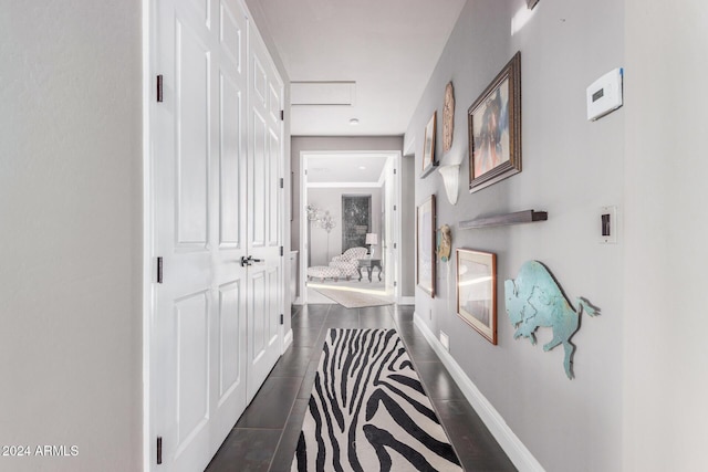 hall featuring dark tile patterned floors