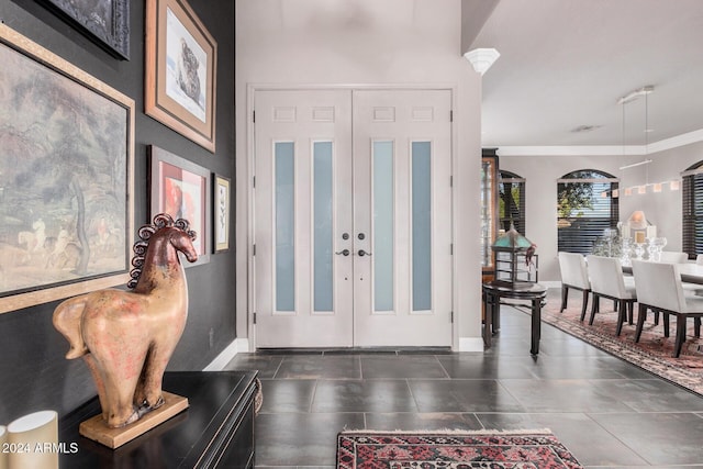 tiled entrance foyer featuring ornamental molding