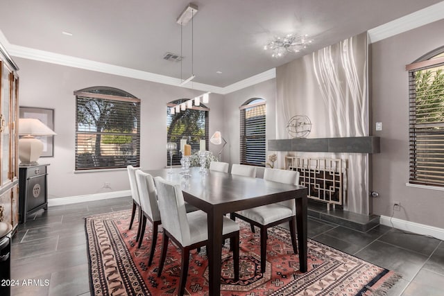 dining space featuring a chandelier, ornamental molding, and a healthy amount of sunlight