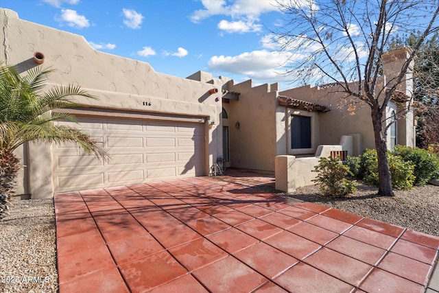 pueblo-style house with a garage