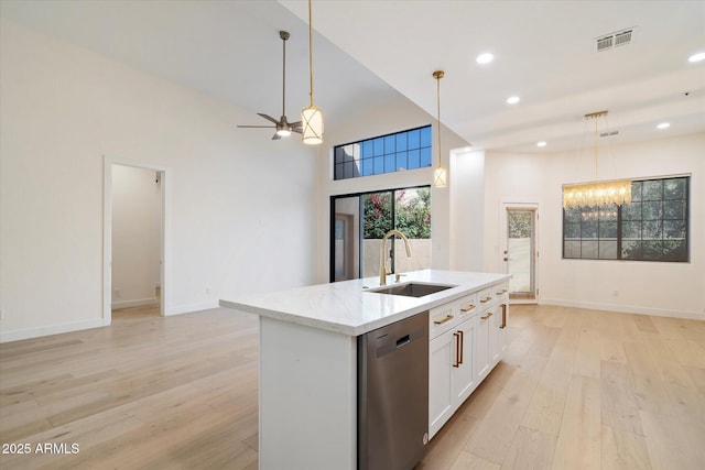 kitchen with sink, dishwasher, an island with sink, white cabinets, and decorative light fixtures