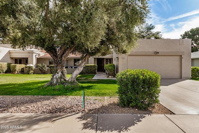 view of front of home featuring a garage and a front lawn