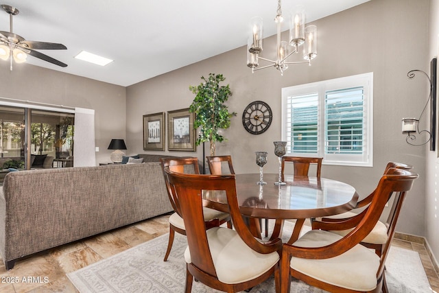 dining area with a healthy amount of sunlight, ceiling fan with notable chandelier, and light hardwood / wood-style floors