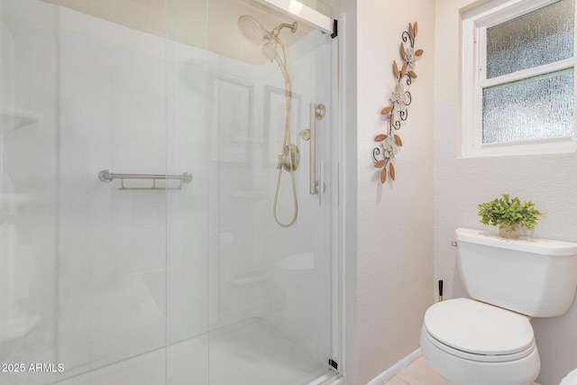 bathroom with toilet and an enclosed shower