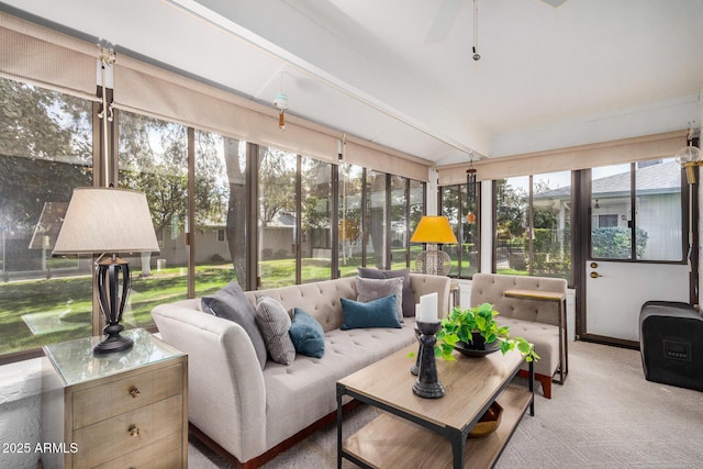 sunroom / solarium with beamed ceiling, a wealth of natural light, and ceiling fan