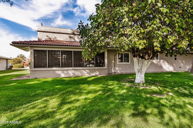 rear view of house with a yard