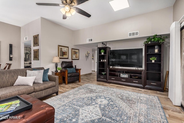 living room featuring ceiling fan and light wood-type flooring