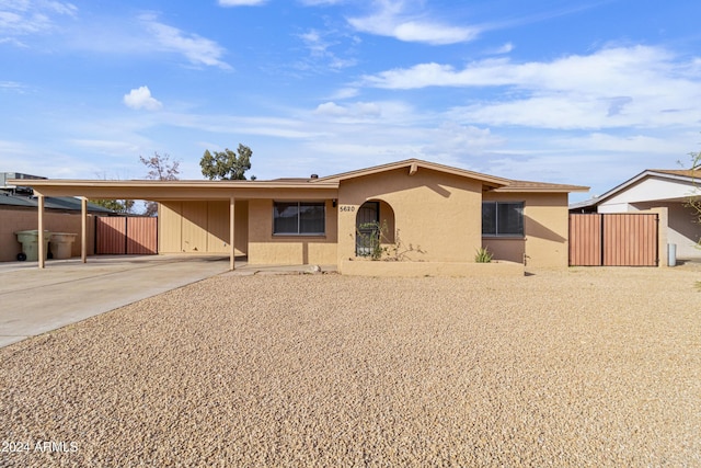 ranch-style house featuring a carport