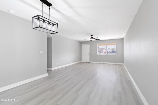 empty room featuring ceiling fan and light wood-type flooring