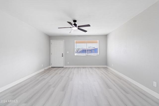 spare room with ceiling fan and light hardwood / wood-style flooring