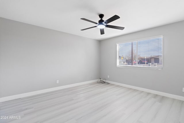 spare room featuring ceiling fan and light hardwood / wood-style flooring