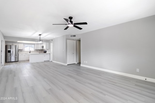 unfurnished living room with light hardwood / wood-style floors and ceiling fan