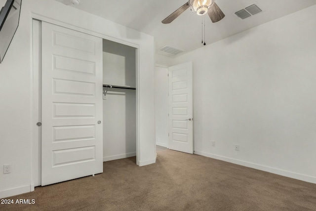 unfurnished bedroom with carpet, ceiling fan, and a closet