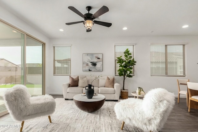 living room with hardwood / wood-style flooring, a wealth of natural light, and ceiling fan