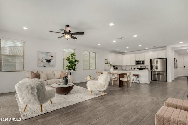 living room featuring dark hardwood / wood-style floors and ceiling fan