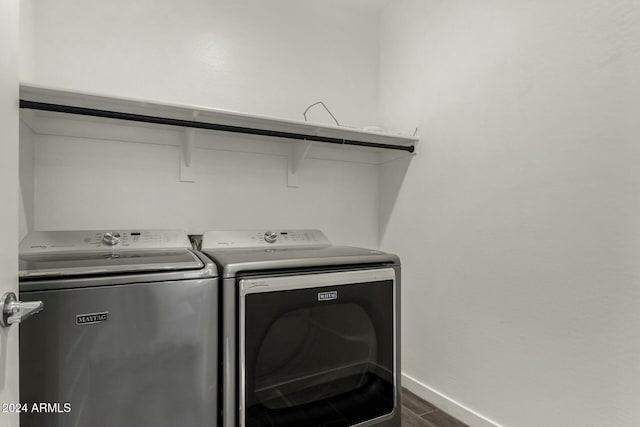 washroom with dark hardwood / wood-style floors and washer and dryer