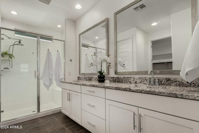 bathroom featuring vanity and a shower with shower door