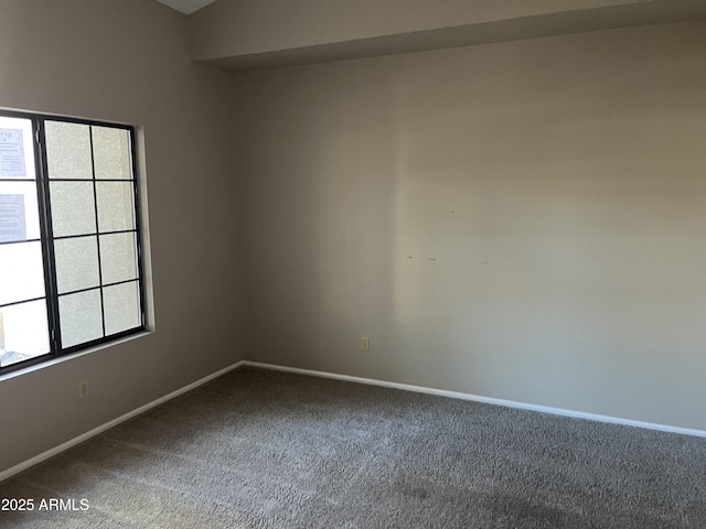 unfurnished room with carpet and baseboards