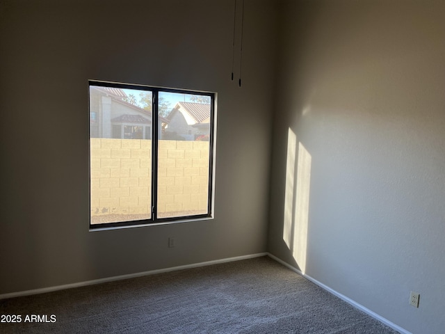 carpeted spare room with baseboards