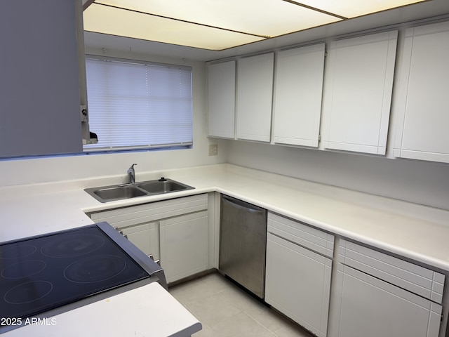 kitchen with stainless steel appliances, light tile patterned flooring, and sink