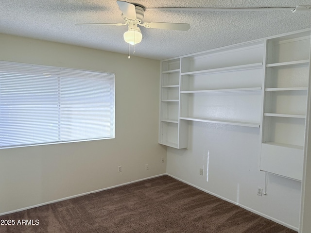 interior space featuring ceiling fan and a textured ceiling