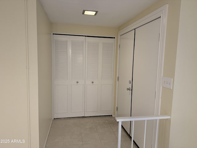 corridor featuring light tile patterned flooring