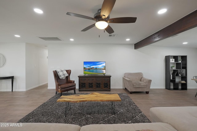 living room with beamed ceiling, ceiling fan, and light hardwood / wood-style floors