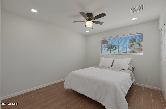 bedroom with ceiling fan and wood-type flooring