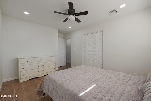 bedroom with dark hardwood / wood-style flooring, a closet, and ceiling fan