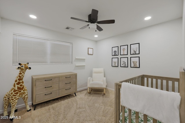 bedroom with ceiling fan and a crib