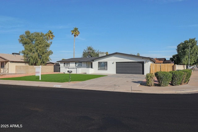 ranch-style home with a garage and a front yard