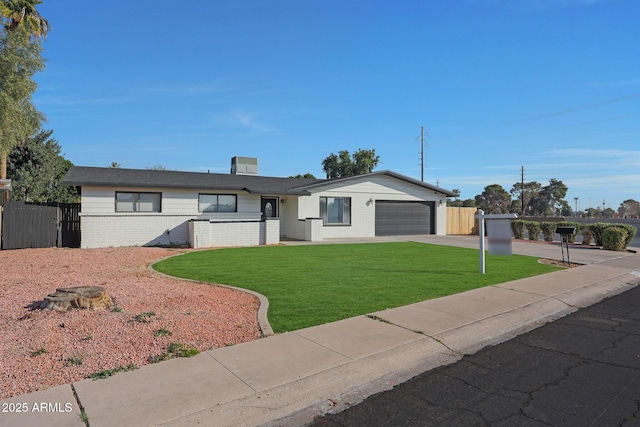 ranch-style home with a garage and a front yard