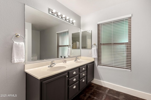 634 W Aviary Way, Gilbert, AZ 85233 - bathroom with double vanity, baseboards, and concrete floors