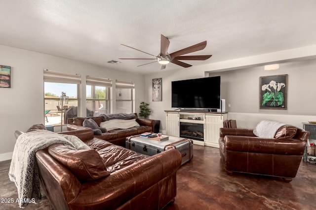 634 W Aviary Way, Gilbert, AZ 85233 - living area with finished concrete floors, ceiling fan, and a glass covered fireplace