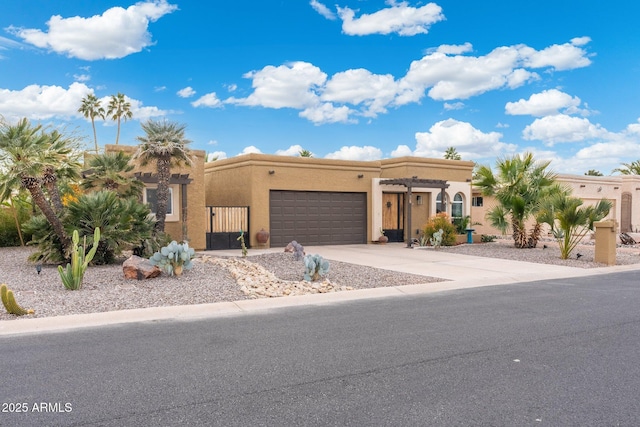 pueblo revival-style home featuring a garage