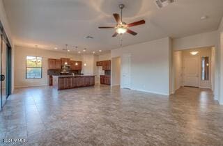 unfurnished living room featuring ceiling fan