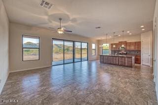 unfurnished living room with ceiling fan