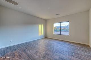 unfurnished room with dark hardwood / wood-style flooring