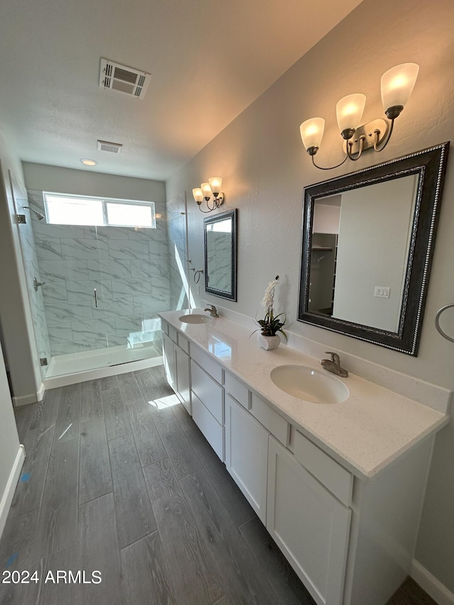 bathroom featuring vanity, hardwood / wood-style flooring, and a shower with shower door