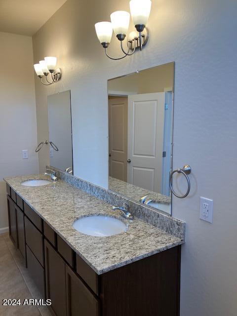 bathroom featuring a chandelier, vanity, and tile patterned flooring