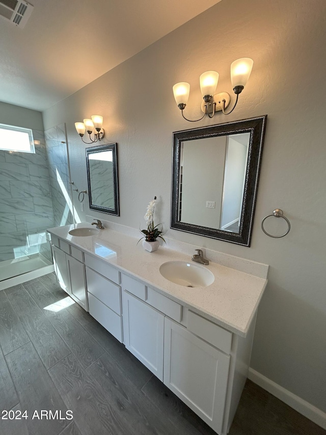 bathroom featuring a tile shower and vanity