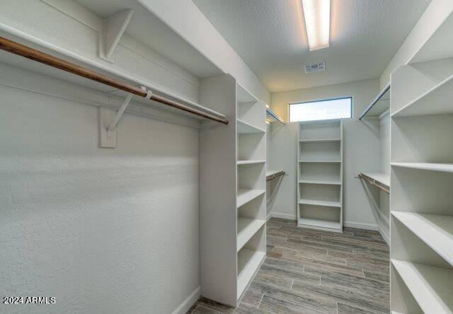 spacious closet featuring hardwood / wood-style flooring