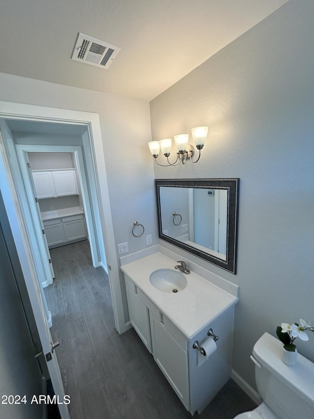 bathroom featuring hardwood / wood-style flooring, vanity, and toilet