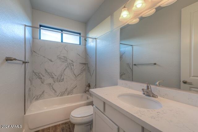 full bathroom with vanity, toilet, and tiled shower / bath