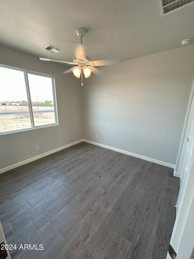 empty room featuring dark hardwood / wood-style floors and ceiling fan